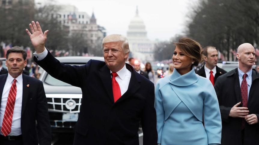 Donald and Melania Trump walk during the inaugural parade.