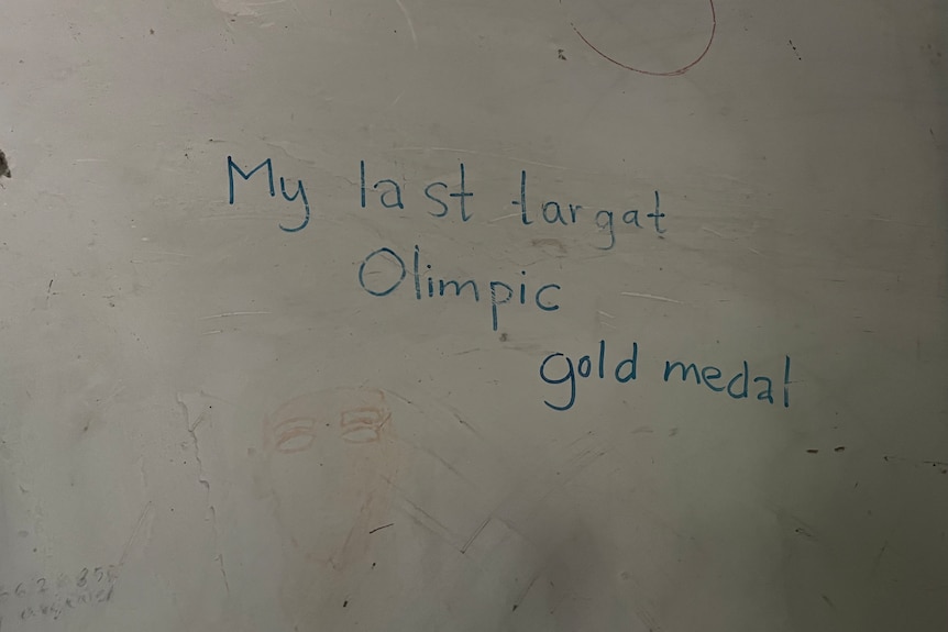 A wall with the following written in texta 'My last targat Olimpic gold medal'