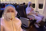 Two people sit on a plane in full PPE, in a screenshot from a Neroli Meadows Instagram story.