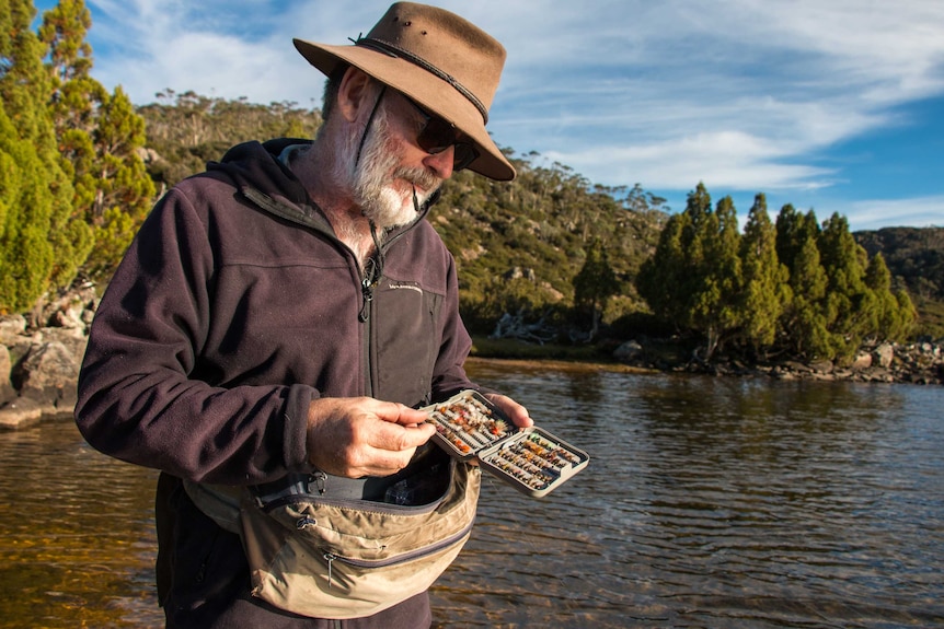 Greg French chooses another fly from his fly box.