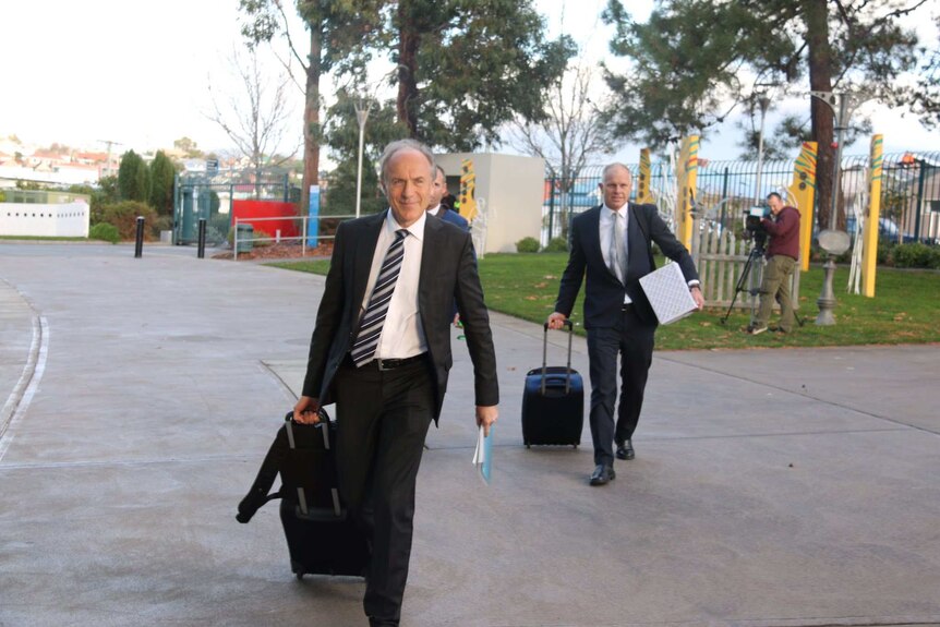 Alan Finkel carries a bag as he arrives for the COAG meeting.
