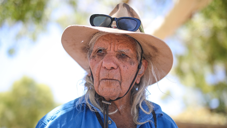 Older man wearing an akubra looking into the distance. 