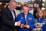 Scott Morrison smiles and gives the thumbs up as a NASA astronaut holds a Gold Logie. Another NASA astronaut holds a plush koala
