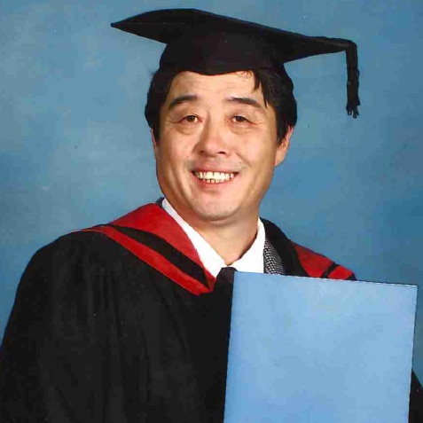 Jae-Ho Oh in a graduation gown and holding his degree.