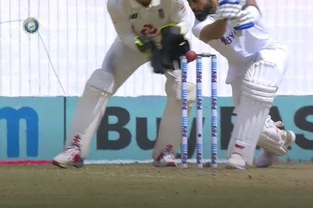Virat Kohli plays a drive but misses the ball that hits the top of off stump