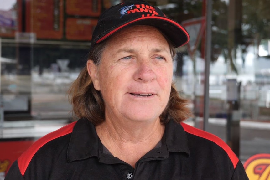 A woman wearing a black and red hat and shirt