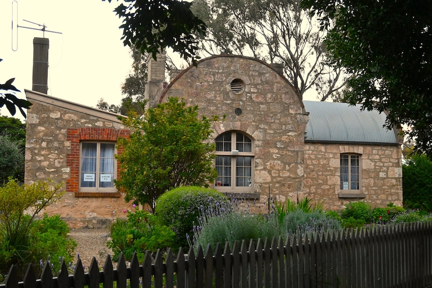 A quirky sandstone building with curved roof