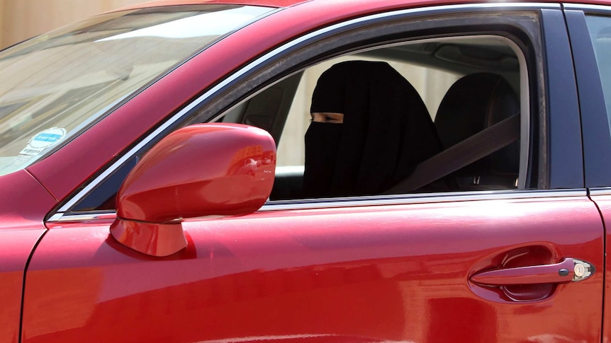 A woman drives a car in Saudi Arabia