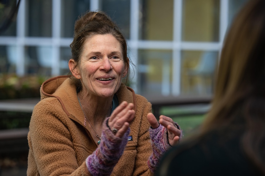 Ruth Pye smiles while gesturing and speaking.