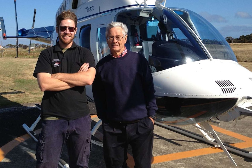 John Osborne with Dick Smith in front of a helicopter.
