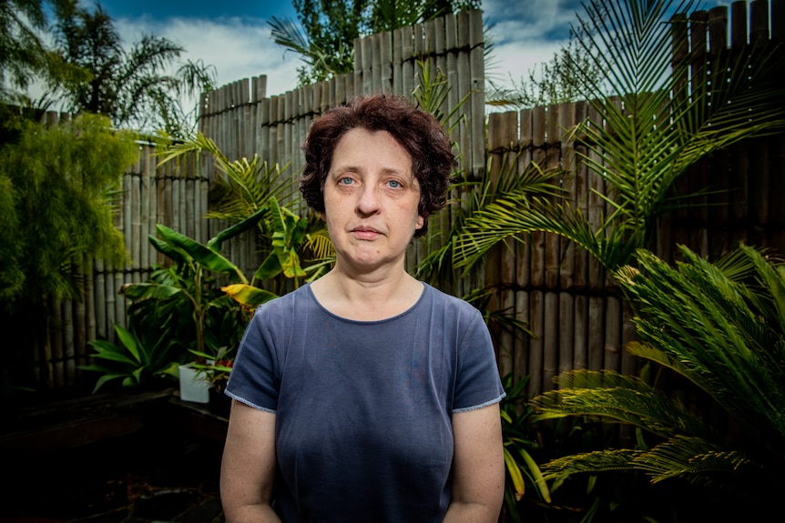 A woman looking upset staring straight down the barrel of the camera