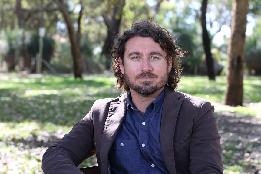 portrait shot of Adin Lang with bushland in the background