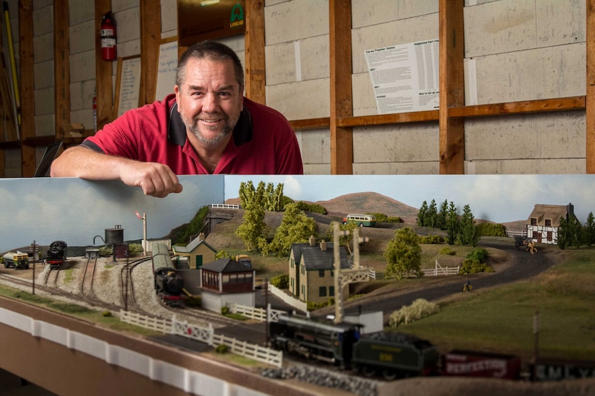 Col Bartley stands next to his model trains.