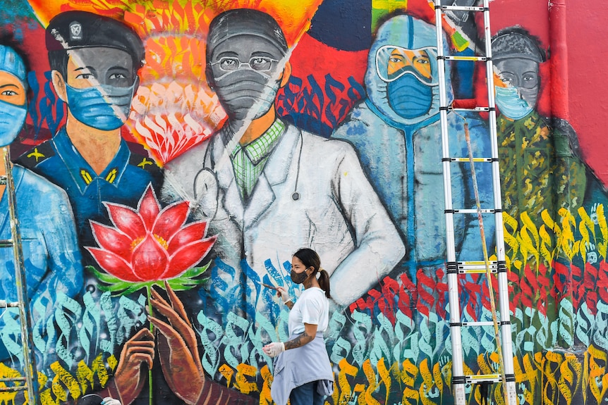 A colourful mural depicting healthcare workers in Nepal