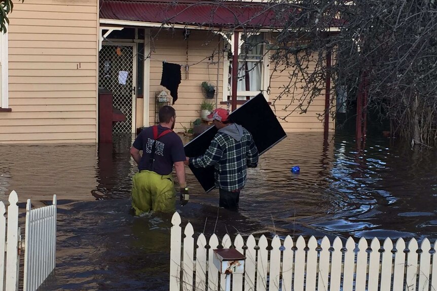 Contents being saved from a home in Huonville inundated by floodwater