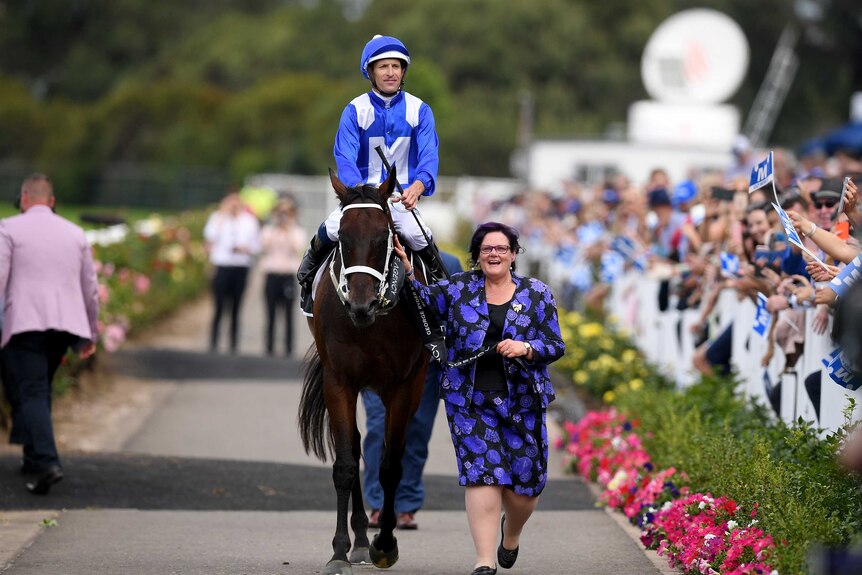Co-owner Debbie Kepitis leads Winx back to the mounting yards at Rosehill Gardens.