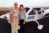 Brian and Pauline stand by a small aircraft.