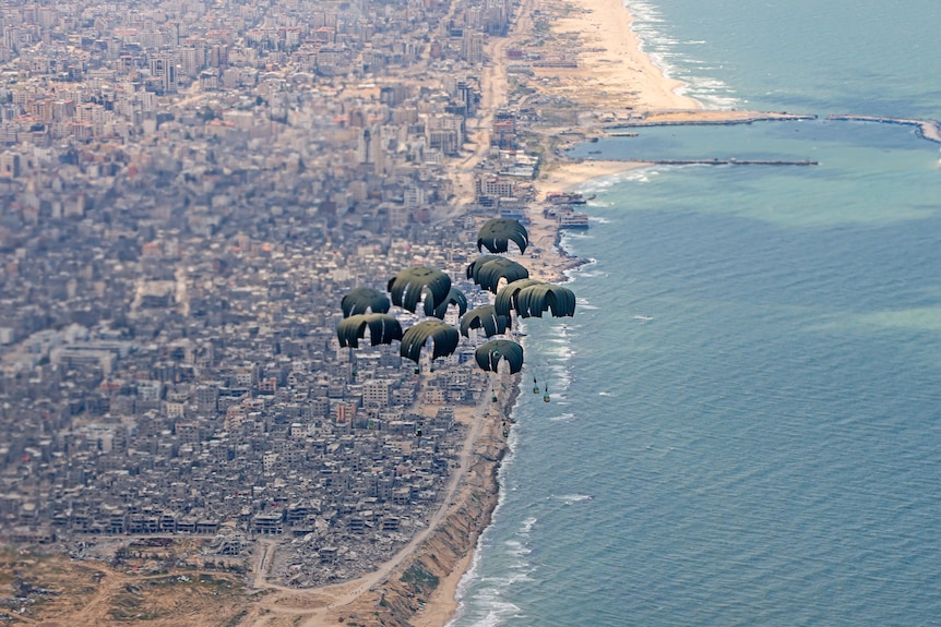 Humanitarian aid attached to parachutes floating over Gaza.