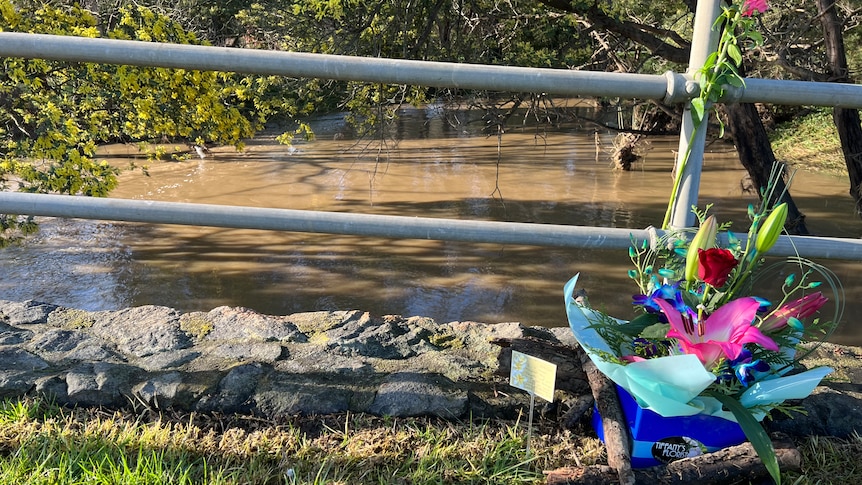 Flowers left for 57-year-old Mari Cao, who died in floodwaters at Traralgon yesterday.