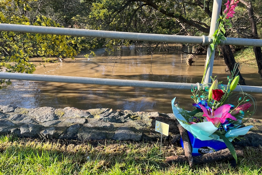 Flowers left for 57-year-old Mari Cao, who died in floodwaters at Traralgon yesterday.