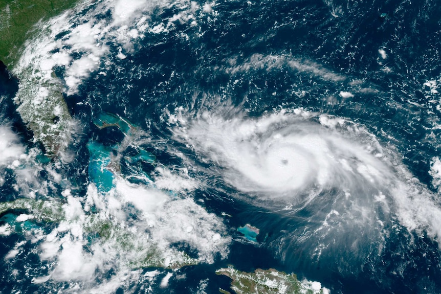 A satelite image shows a hurricane approaching the Florida coast while moving through Caribbean waters