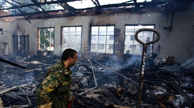 Devastated: A fireman inspects the school gym during rescue operations.