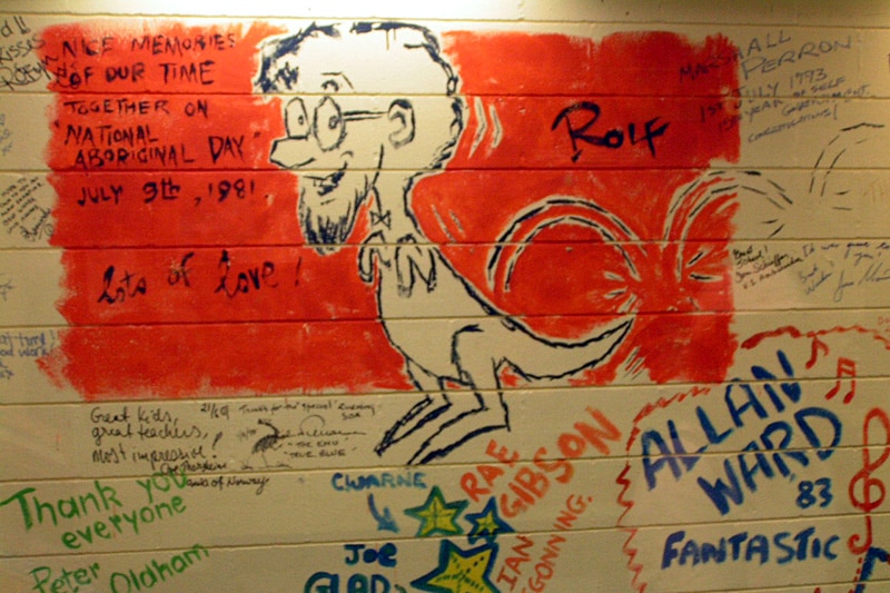 A cartoon self-portrait of Rolf Harris painted onto a wall at the Alice Springs School of the Air.
