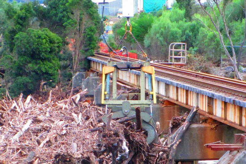 Flood debris on the Emu River rail bridge at Burnie