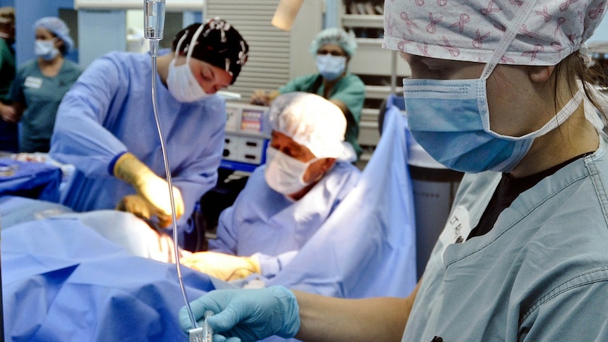 Nurses and doctor pictured during medical procedure, generic image.