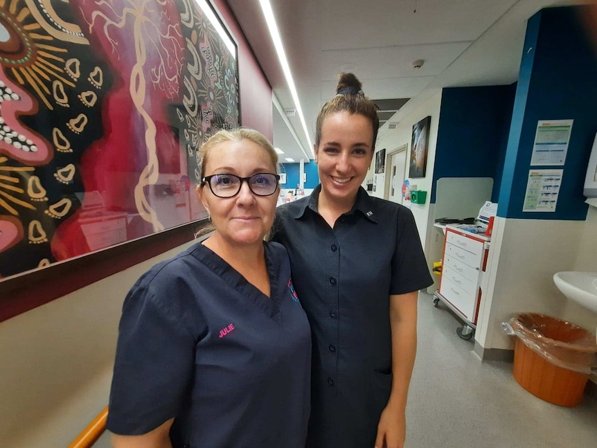 Two midwives standing in hospital ward