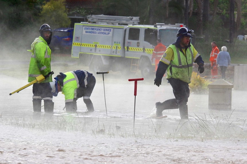 Workers trying to fix the burst water main.