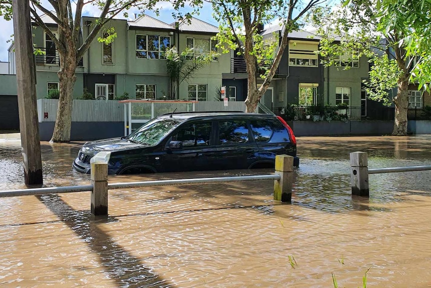 A car flooded in a street.