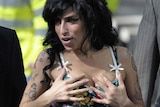 Amy Winehouse grabbing her breasts.