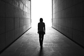 An unidentified person walks down a laneway. (Louis du Mont/Flickr)