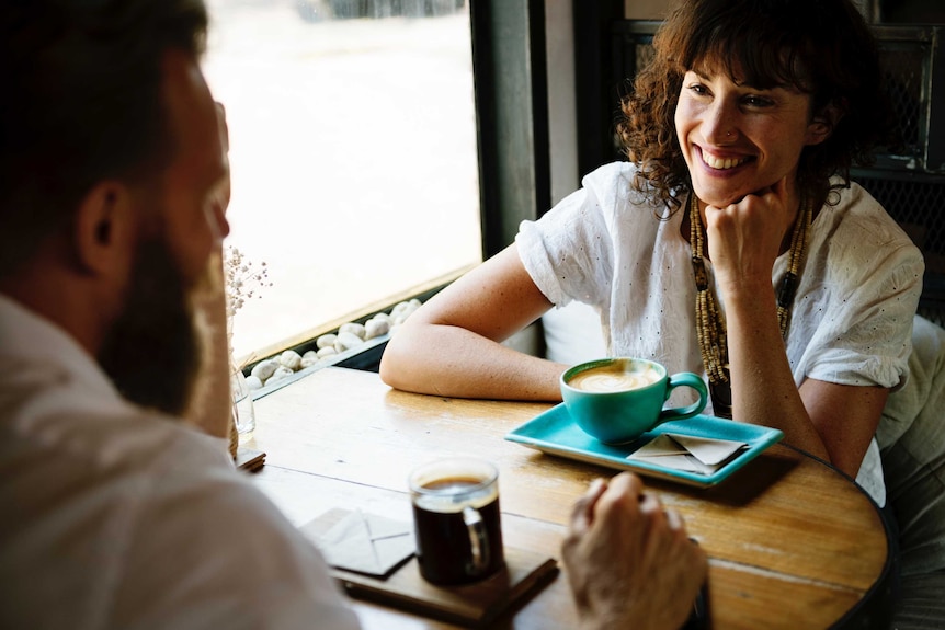 Couple chat over coffee in a cafe