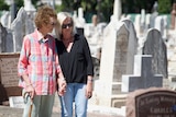 Deirdre and Lesley Rudd look at headstones.