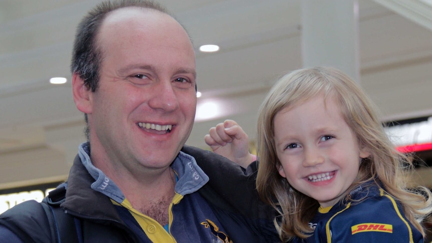 Brumbies fans Ivan Gavazou and daughter Milicia brought along a football to be signed by their favourite players.