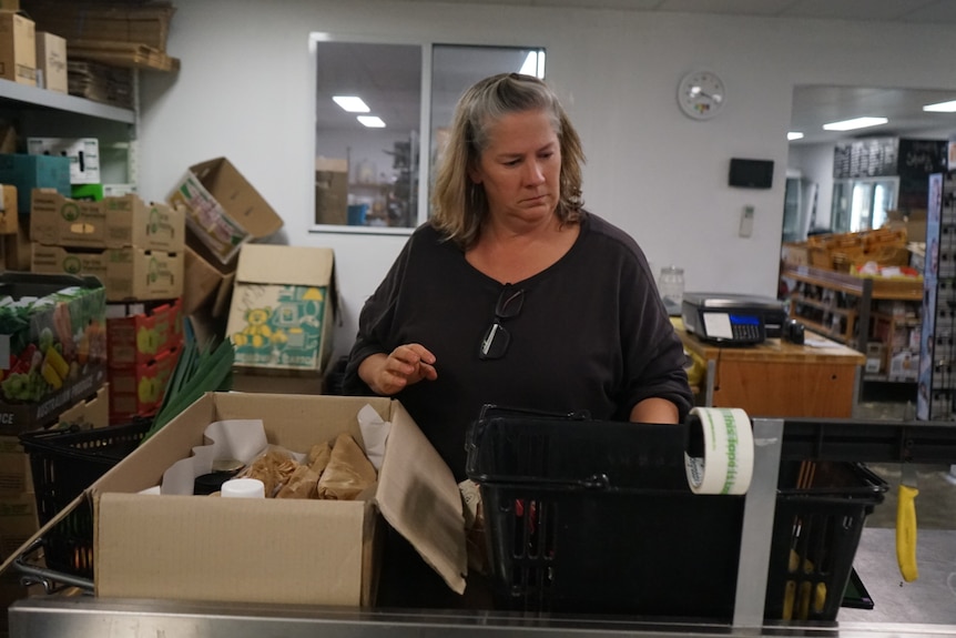Loren McMath packing a box in her organic store.