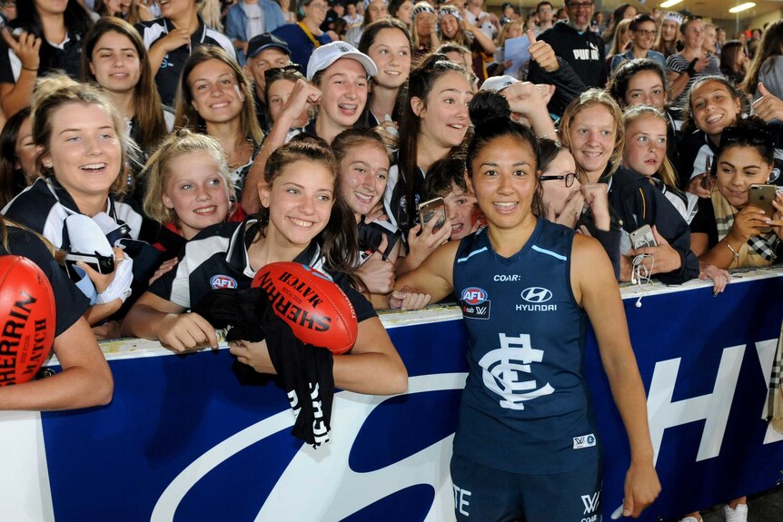 Darcy Vescio stands in front of the AFLW crowd