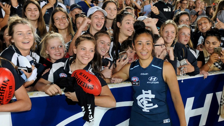 Darcy Vescio stands in front of the AFLW crowd