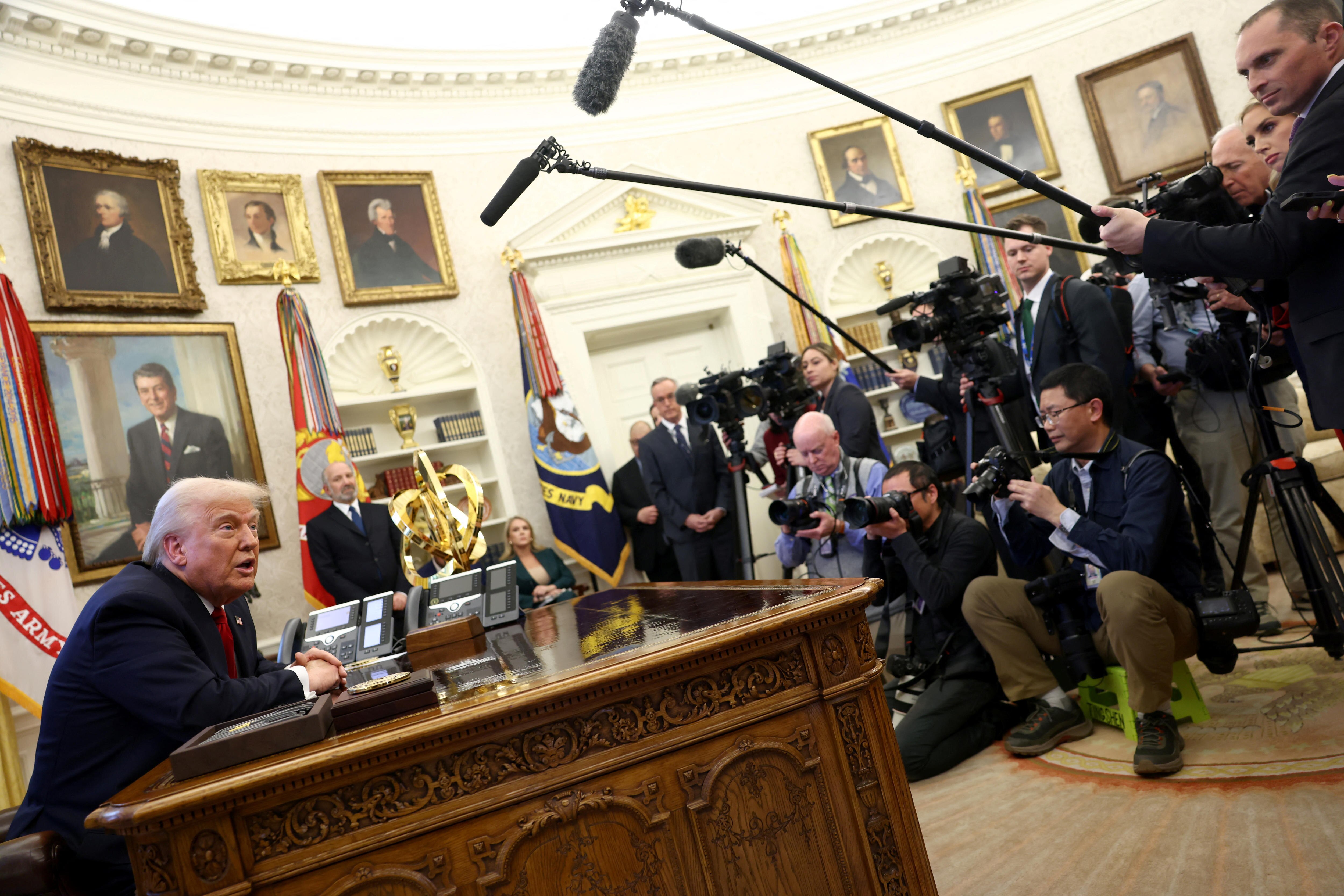  Donald Trump speaks to the media in the Oval Office at the White House