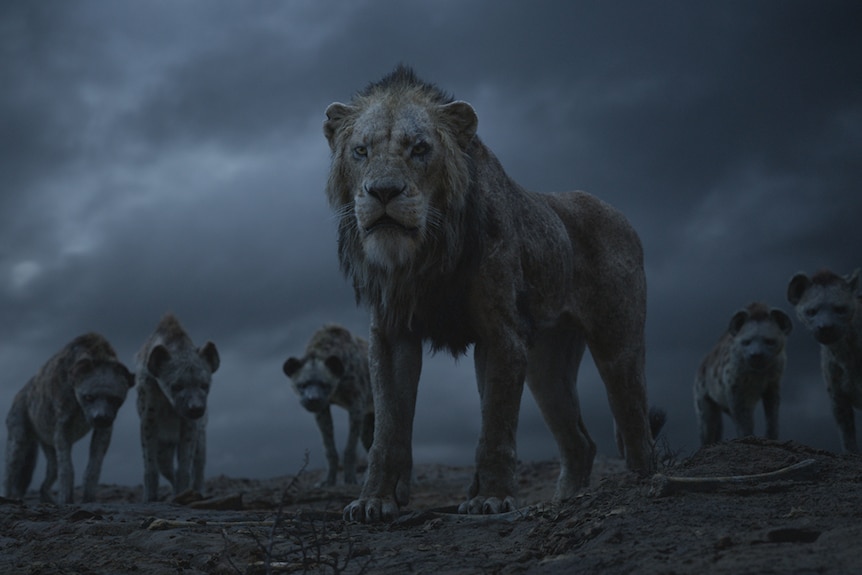 Colour still of animated lion Scar standing with a pack of hyenas in front of dark sky in 2019 film The Lion King.