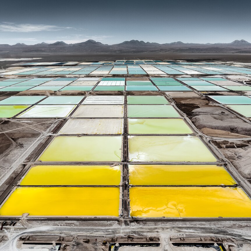 artificial yellow white and blue large pools in a desert 