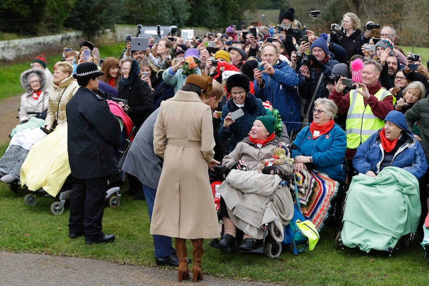 Meghan Markle and Prince Harry greet well wishers following the traditional Christmas Day church service