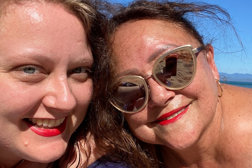 lady in red lipstick next to a lady in sunglasses