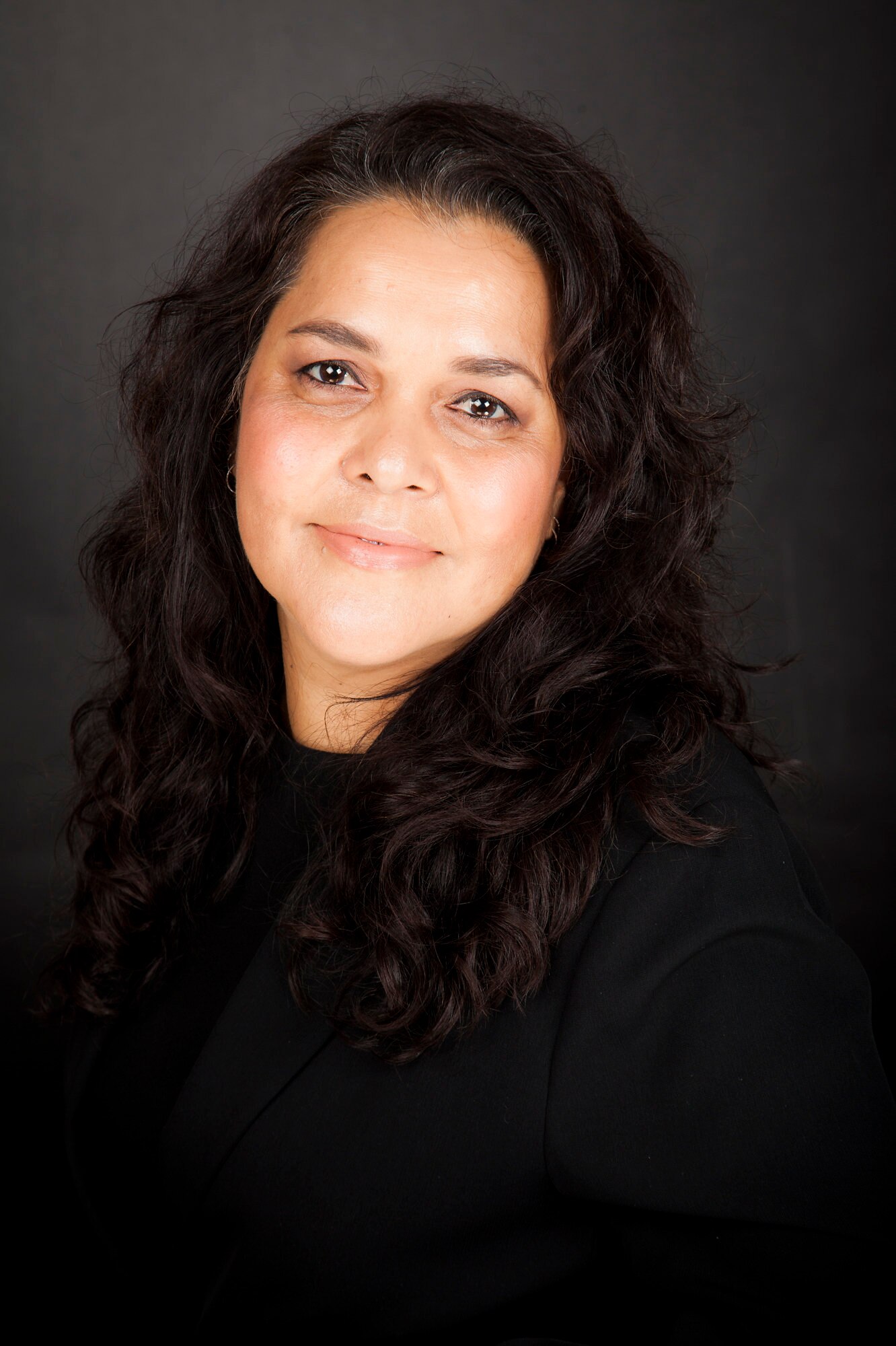 A portrait photo of a woman looking at the camera