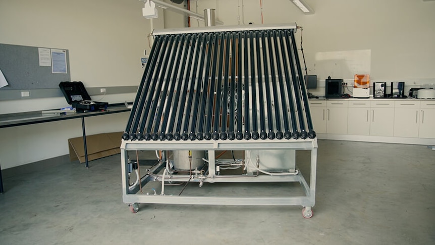 Metal frame in a laboratory carrying a series of black heating tubes and boxes for roof mounting.