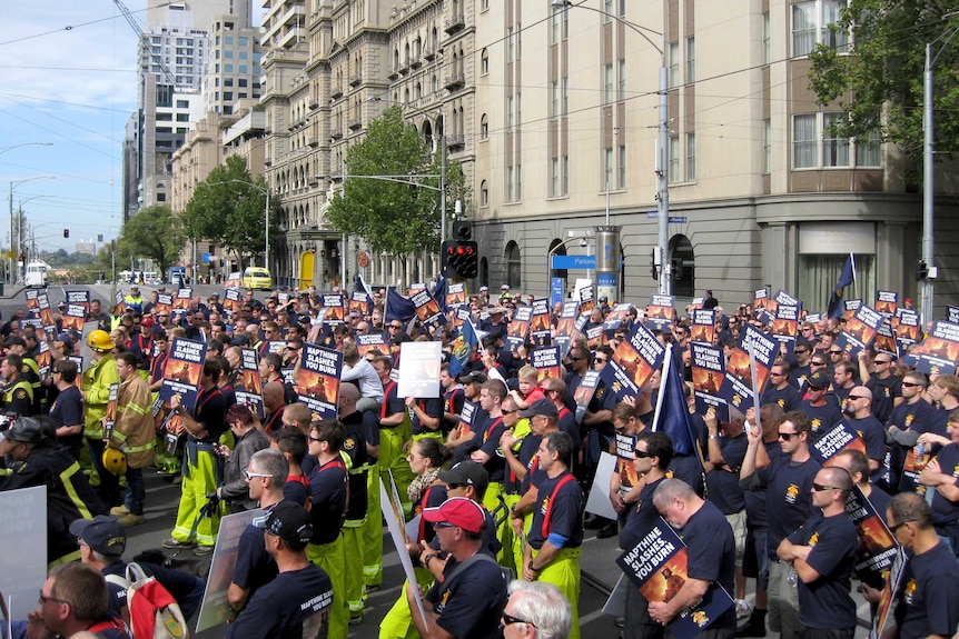 Firefighters rally outside Parliament House in Melbourne after marching through the city centre.