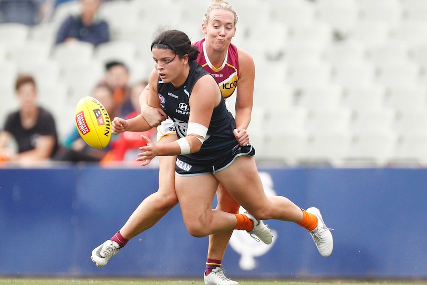 Maddison Prespakis is being tackled as she gets a handball out.