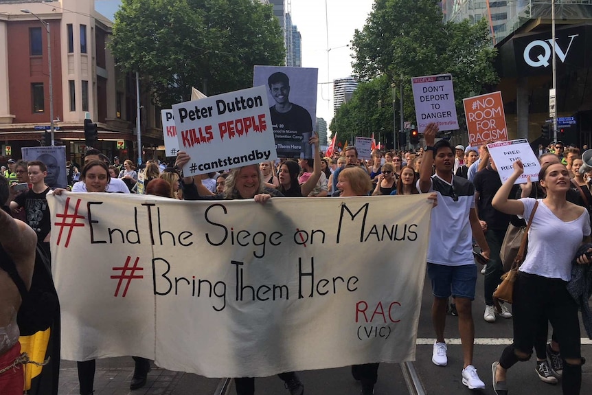 Protesters carrying signs march in central Melbourne against the Manus Island detention centre on 10 March 2017.